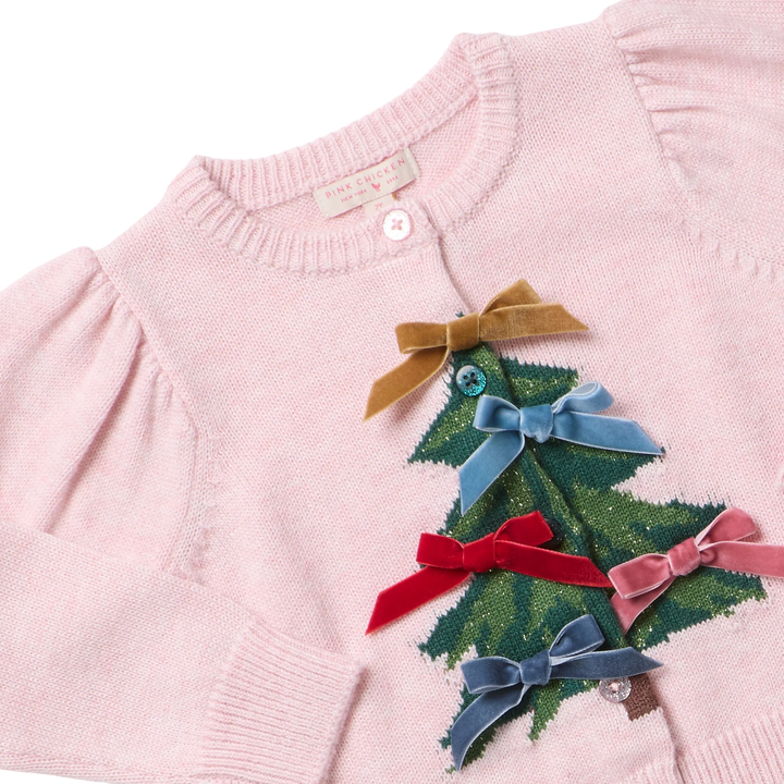 Close-up of Girls Constance Sweater showing green Christmas tree design, colorful velvet bows, puff sleeves, and button details