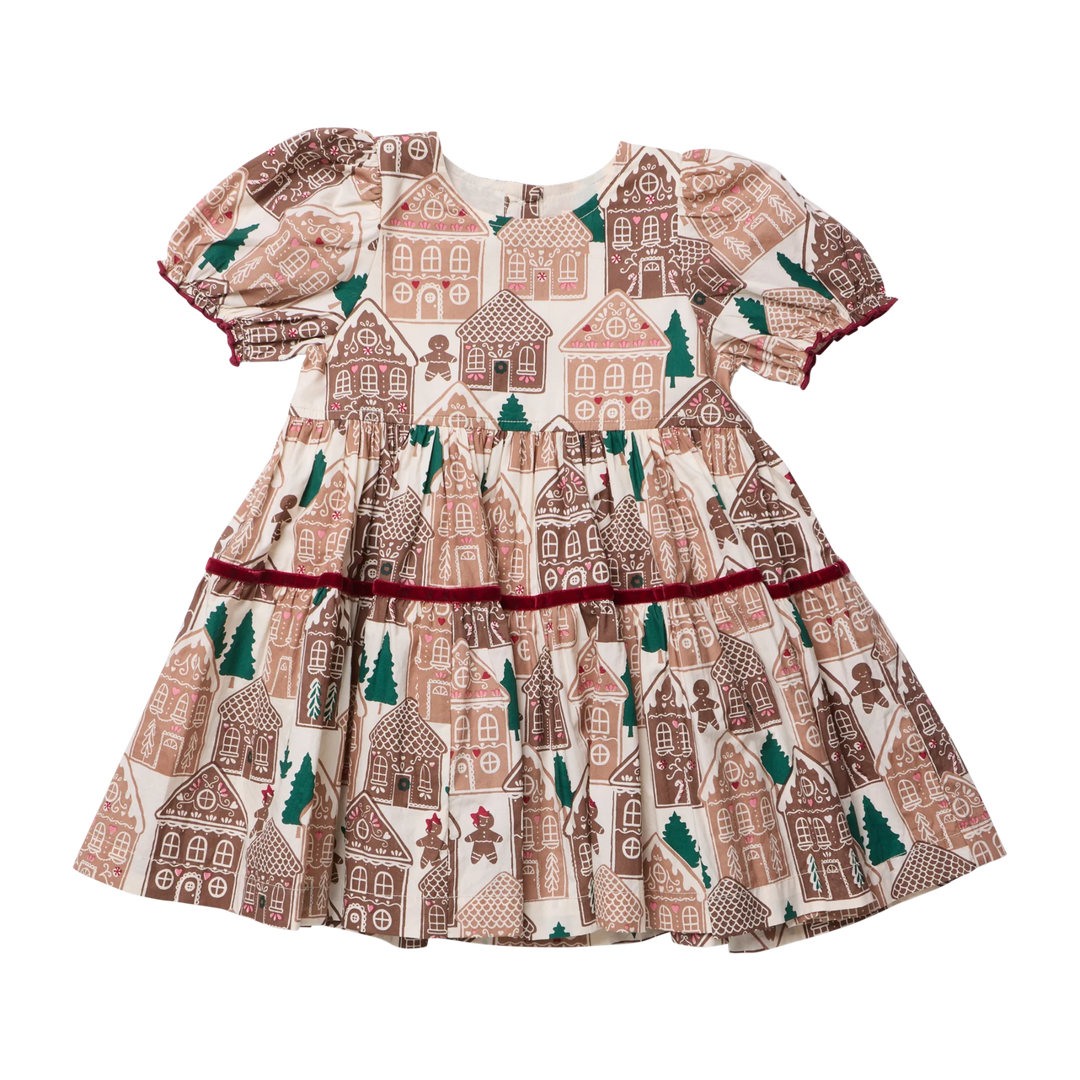 Back view of the Pink Chicken Girls Eliza Dress in Gingerbread Houses featuring puff sleeves, a gathered waist, burgundy velvet trim, and a festive tiered skirt.