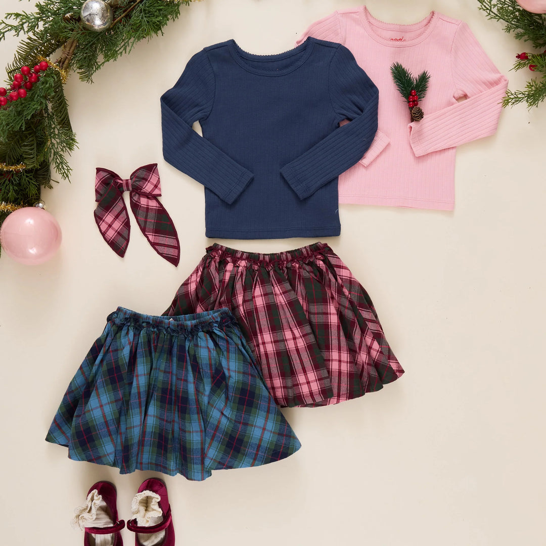 Girls Gianna Skirt in Blue Tartan styled with a navy long sleeve top alongside coordinating pink plaid holiday clothing
