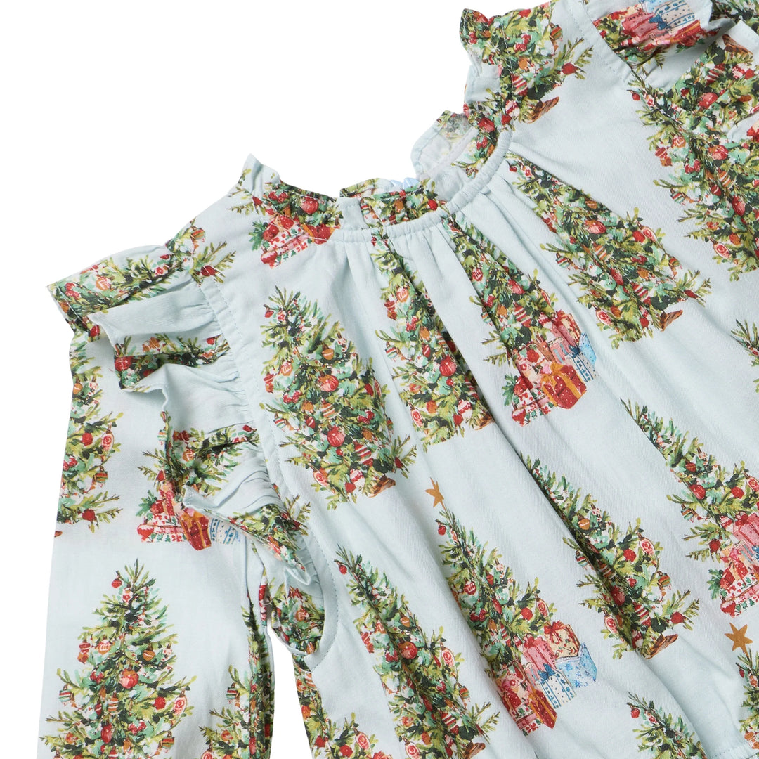 Close-up of the Girls Harper Dress in Trees and Presents showing layered shoulder ruffles, gathered neckline, and festive Christmas tree print.