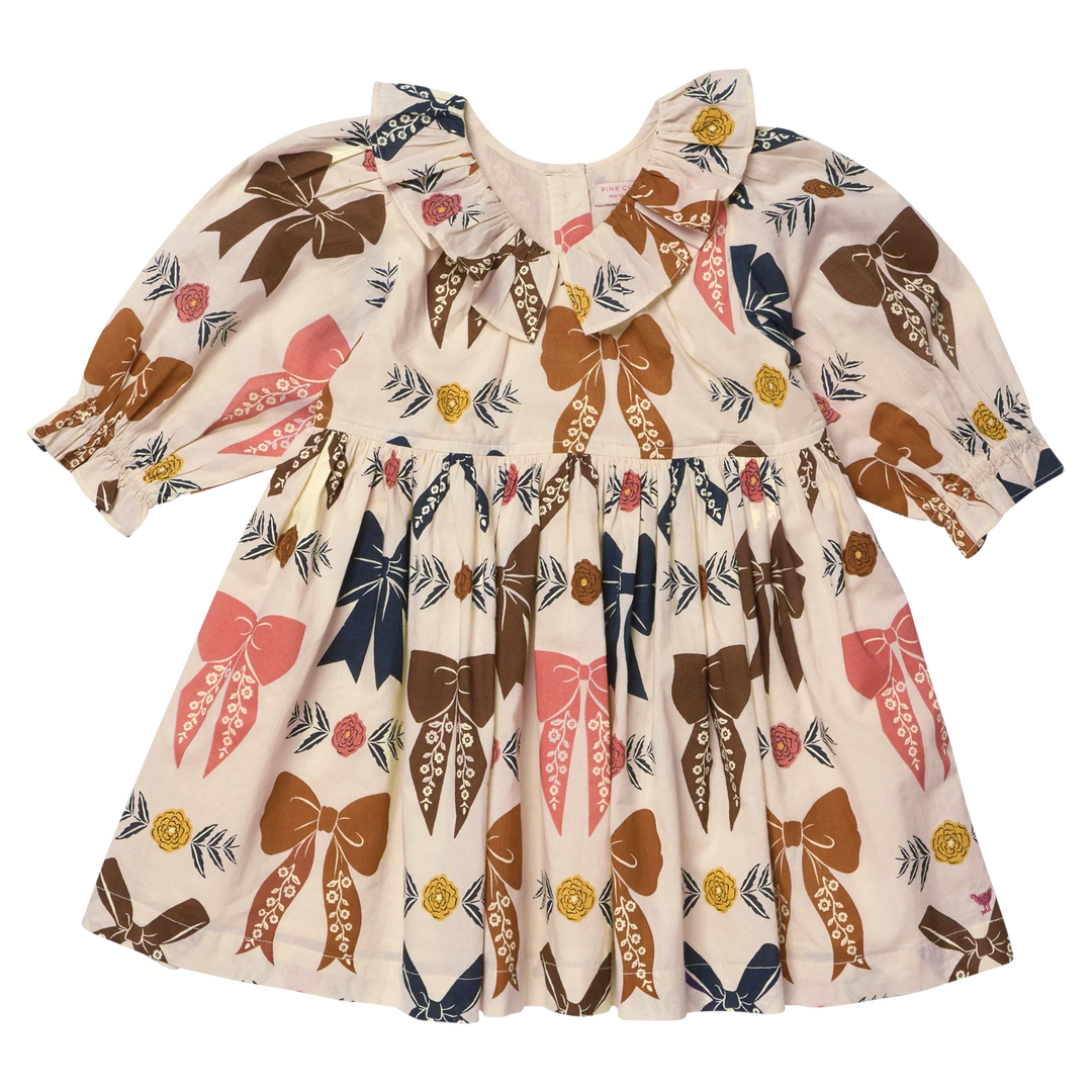 Girls Harvest Bow Dress in cream with colorful brown, pink and navy bows and floral accents