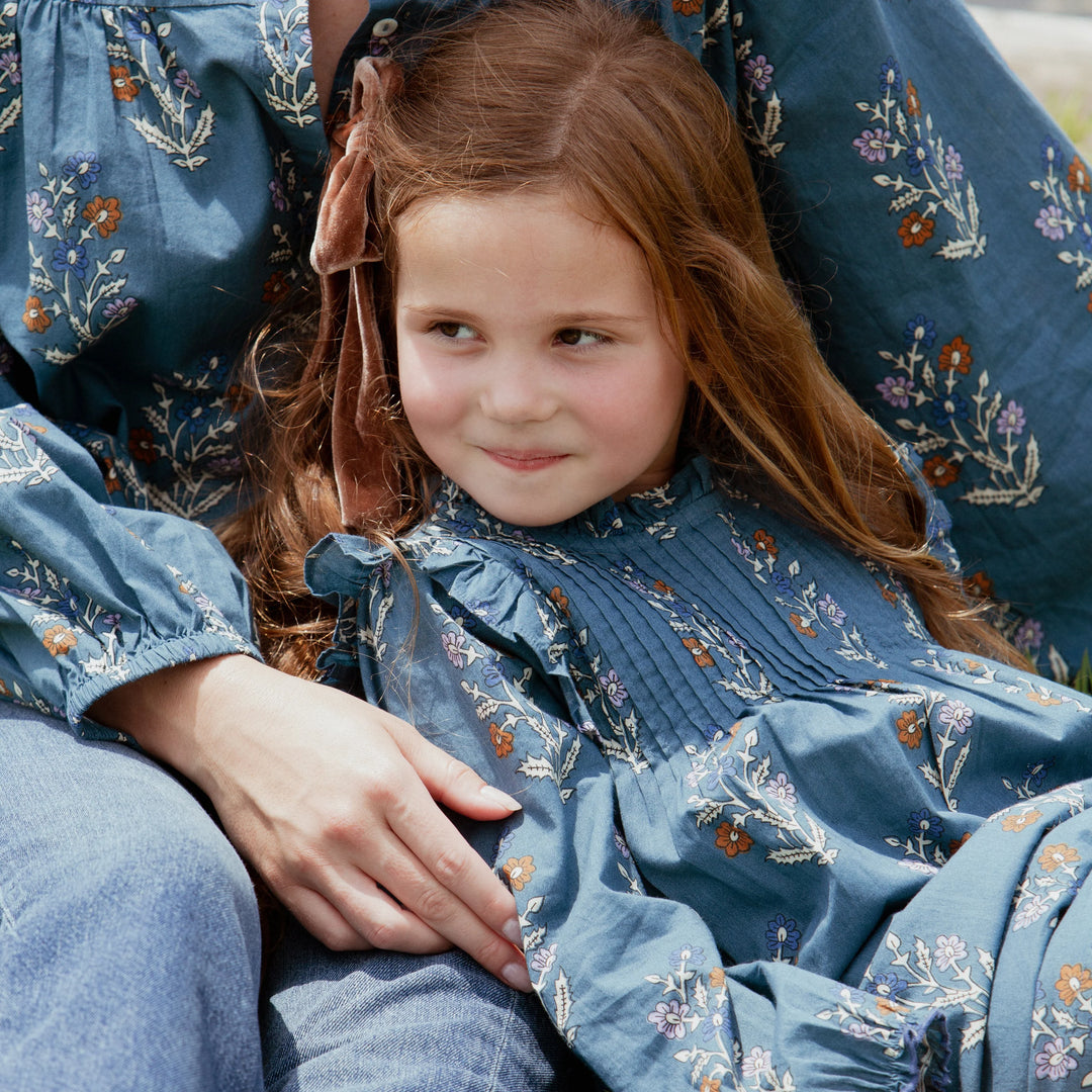 Girl wearing Girls Jaipur Dress Balsam Dewdrop in blue floral print with ruffle detailing