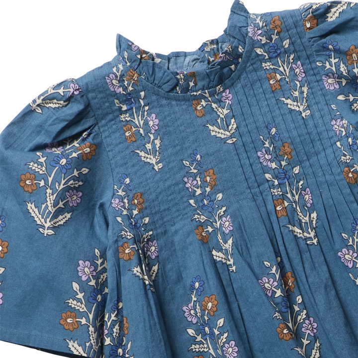 Close-up of Girls Jaipur Top Balsam Dewdrop ruffle neckline, pintuck front, and floral print