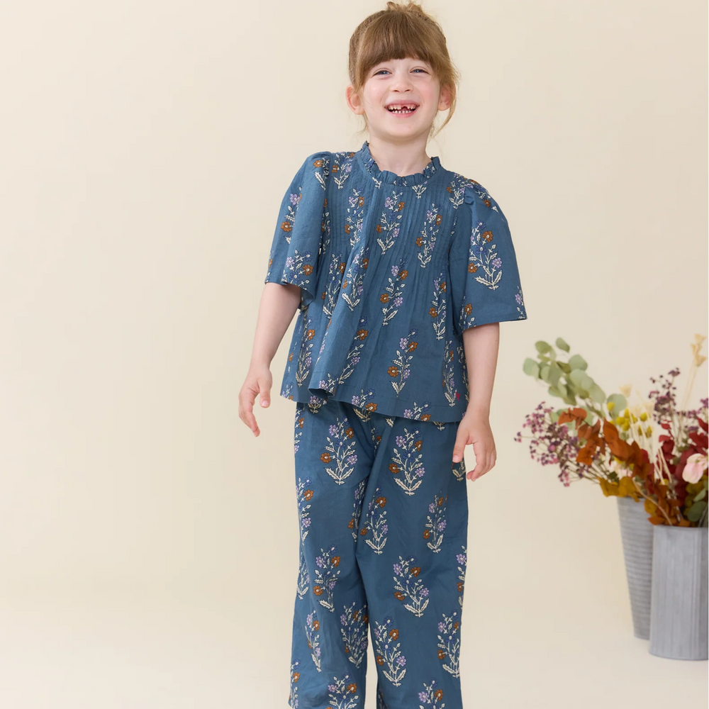 Girl wearing Girls Jaipur Top Balsam Dewdrop with coordinating floral Theodore pants