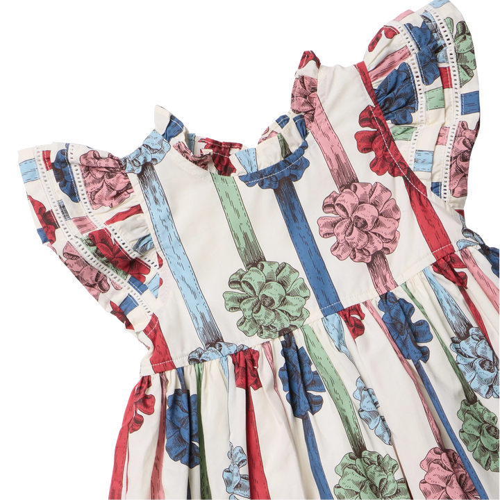 Close-up of Girls Jennifer Dress showing colorful present bow print, layered ruffle sleeves, and delicate eyelet trim