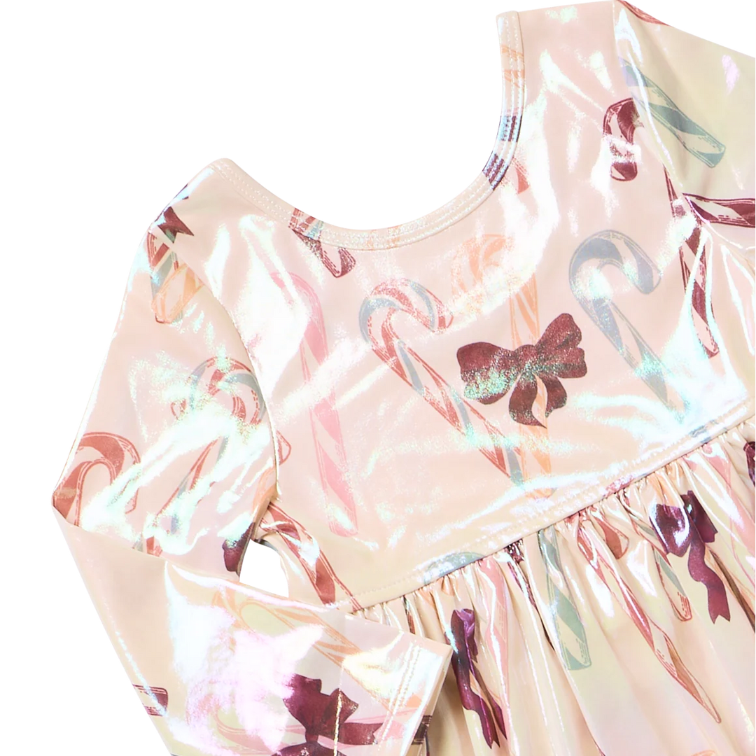 Close-up of Girls Lame Steph Dress showing iridescent fabric, pastel candy cane print, burgundy bow details, round neckline, and gathered waist.