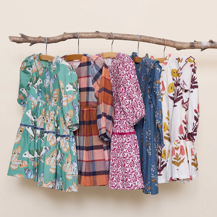 Girls Maribelle Dress in Burgundy Climbing Floral displayed with coordinating fall dresses
