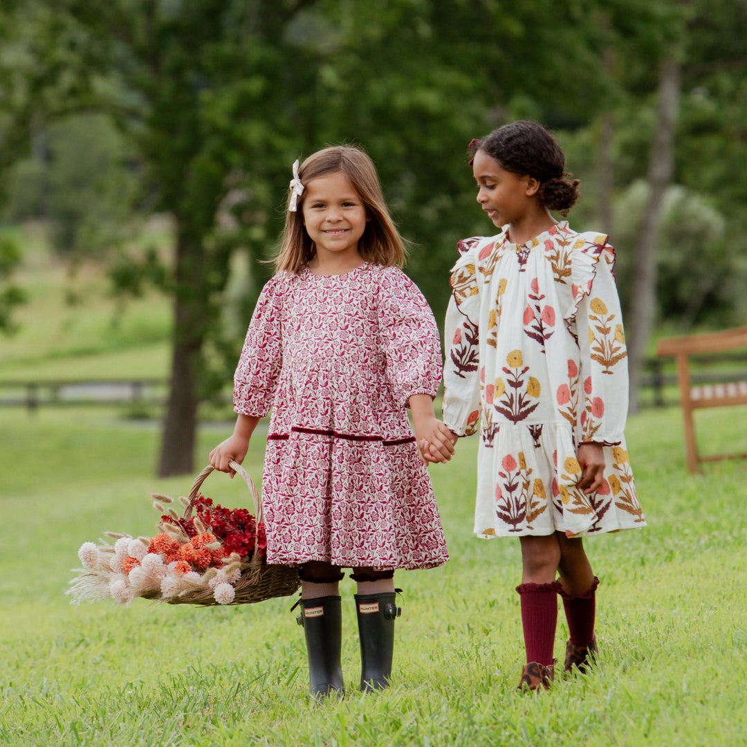 Girl wearing Burgundy Climbing Floral Maribelle Dress with friend outdoors in fall