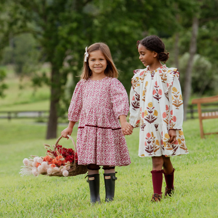 Girl wearing Burgundy Climbing Floral Maribelle Dress with friend outdoors in fall