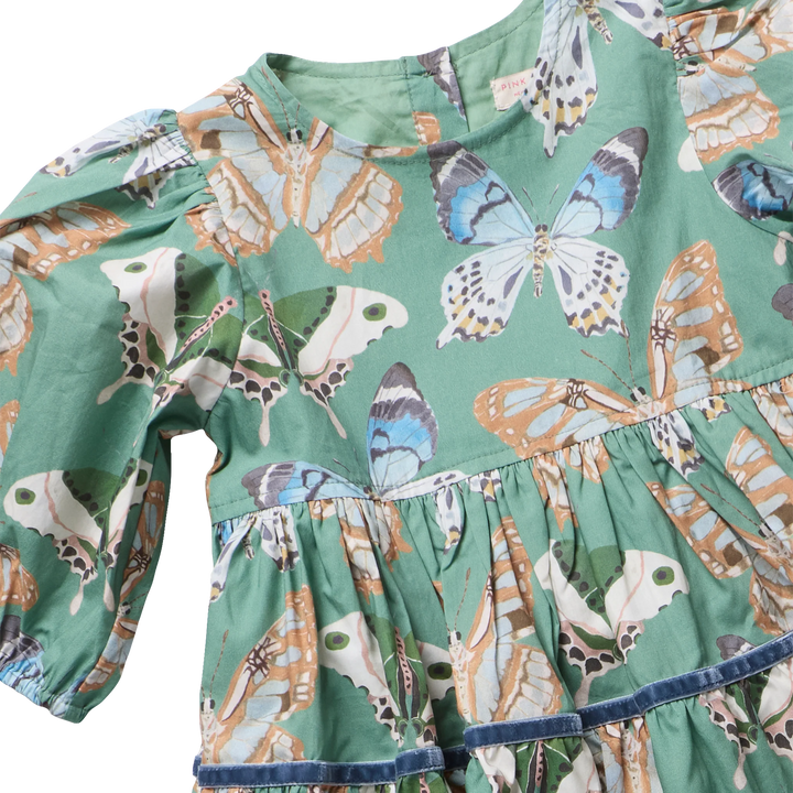 Close-up of Girls Maribelle Dress Green Butterflies showing colorful butterfly print and velvet trim