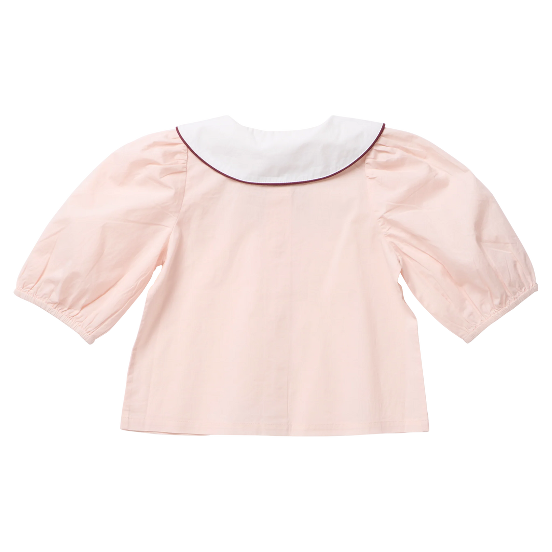 Back view of the Pink Chicken Girls Noelle Top in blush pink featuring puff sleeves and a white Peter Pan collar trimmed with burgundy piping.