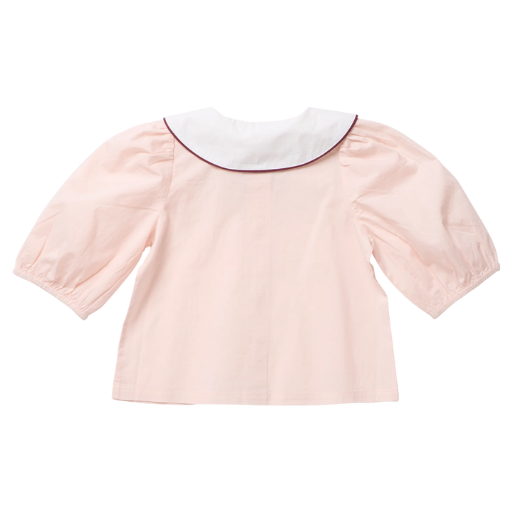 Back view of the Pink Chicken Girls Noelle Top in blush pink featuring puff sleeves and a white Peter Pan collar trimmed with burgundy piping.