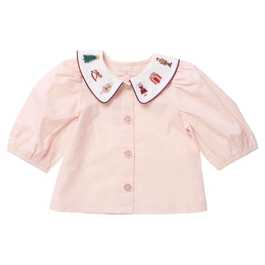 Pink Chicken Girls Noelle Top in blush pink featuring puff sleeves, sparkling buttons, and a white Nutcracker embroidered Peter Pan collar.