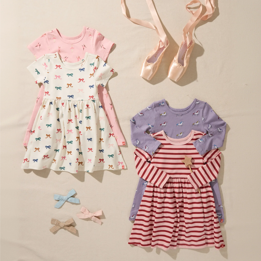 Girls pink and red striped long sleeve dress displayed with coordinating printed girls dresses, ballet slippers, and hair bows.