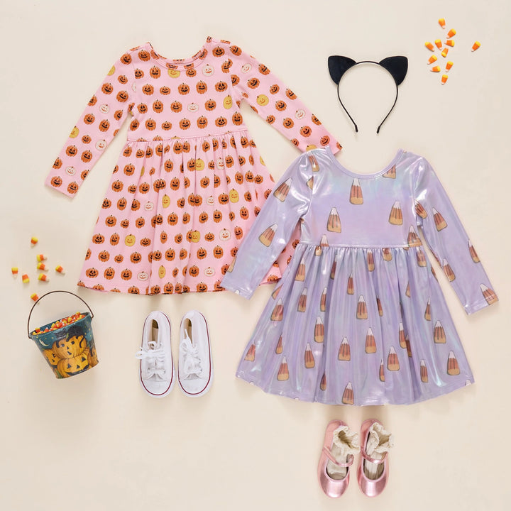 Pink girls pumpkin Halloween dress styled with a lavender candy corn dress, cat ears, candy corn, trick-or-treat bucket, and shoes.