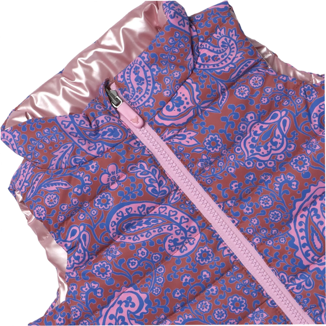 Close-up of Girls Reversible Riley Vest showing purple, pink, and blue paisley print and pink zipper