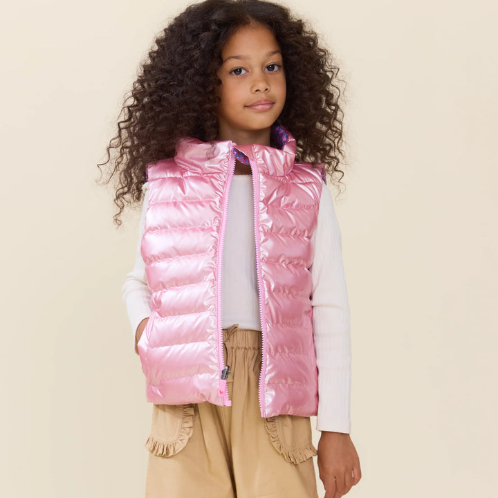 Girl wearing the shiny pink side of the Reversible Riley Vest Purple Paisley Vines