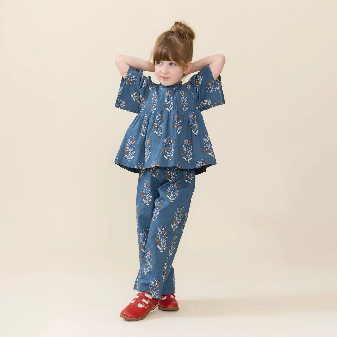Girl wearing Girls Theodore Pant in Balsam Dewdrop with coordinating blue floral top