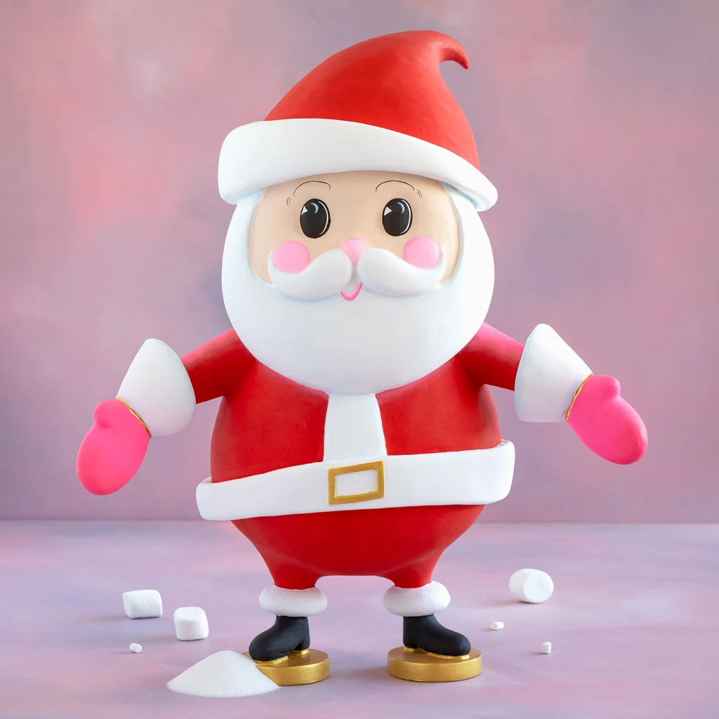 Glitterville Baby Papa Noel cartoon-style Santa Claus display figure in a red suit and Santa hat with pink mittens, white beard, and gold accents.