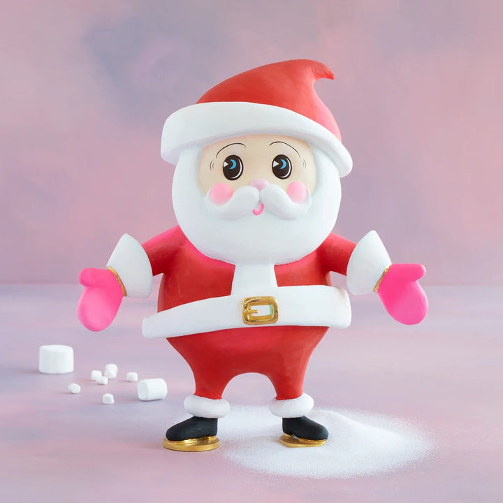 Glitterville Baby Papa Noel small Santa Claus display figure in a red suit and Santa hat with pink mittens, white beard, gold accents, and black boots.