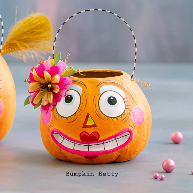 Glitterville Bumpkin Betty pumpkin bucket featuring playful face, colorful floral accents, and whimsical Halloween details.
