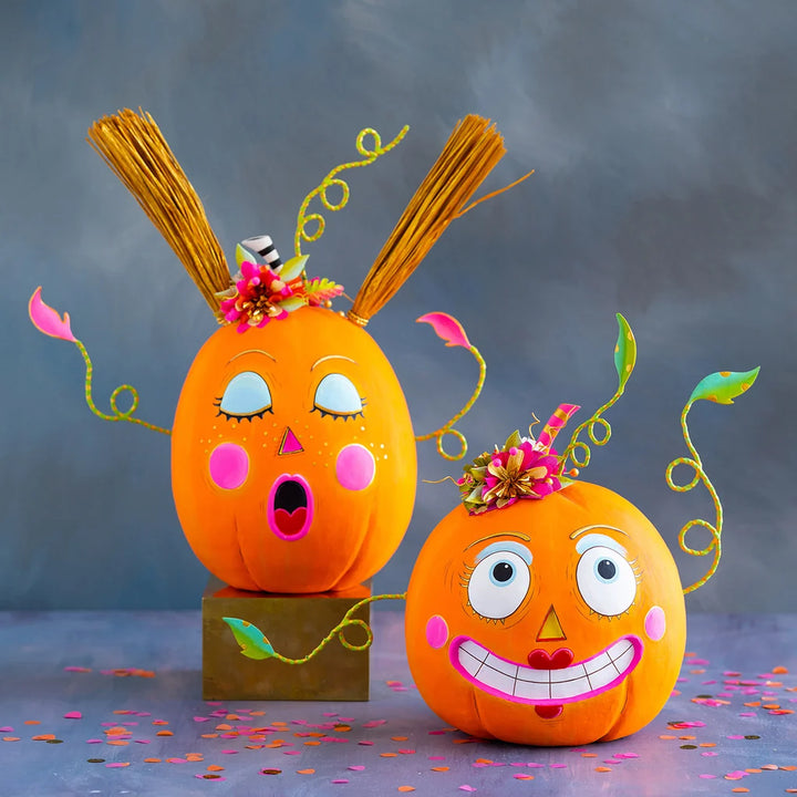Glitterville Bumpkin Betty and Gossip Gourdy pumpkin display size figurines featuring playful faces, colorful floral accents, and whimsical Halloween details.