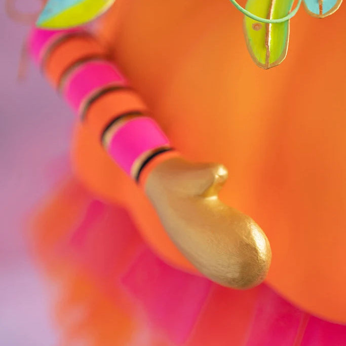 Glitterville Fairy Gourdmother large display close-up showing the gold hand, pink and orange striped arm, and orange pumpkin skirt.