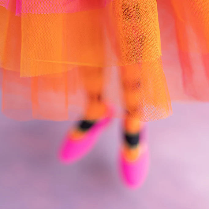 Glitterville Fairy Gourdmother large display close-up showing her layered orange and pink tulle skirt, striped legs, and bright pink shoes.