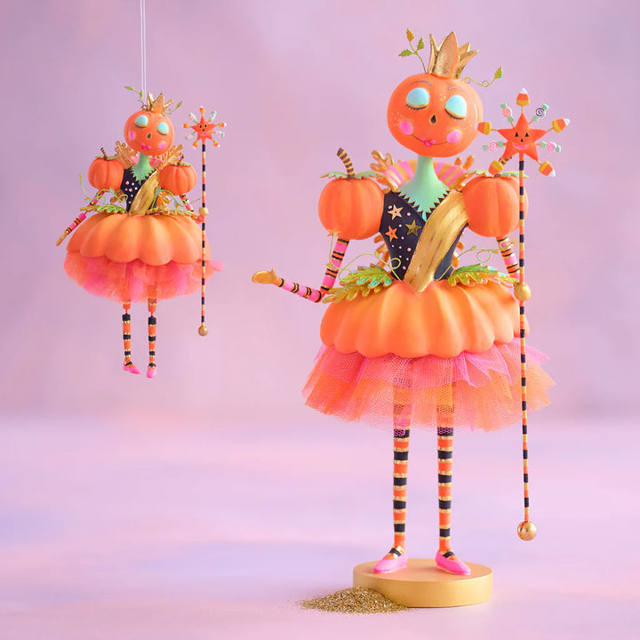 Glitterville Fairy Gourdmother ornament shown beside the larger tabletop version for size comparison, featuring pumpkin-inspired fairy designs in orange, pink, and gold.