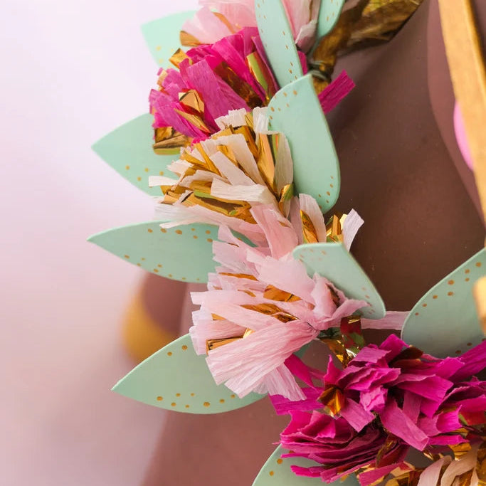 Glitterville Gallop the Horse floral garland close-up featuring pink and white flowers, mint green leaves, and gold accents.