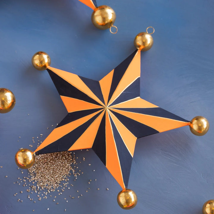 Glitterville Halloween Stripe Star Set orange and black striped star with gold ball accents and glitter detail.