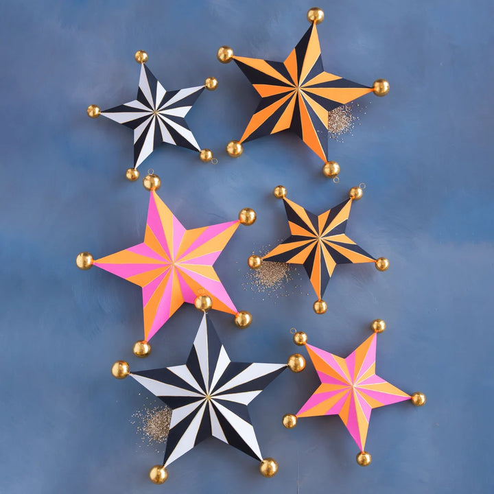 Glitterville Halloween Stripe Star Sets featuring small and large striped stars in black, white, orange, pink, and gold.