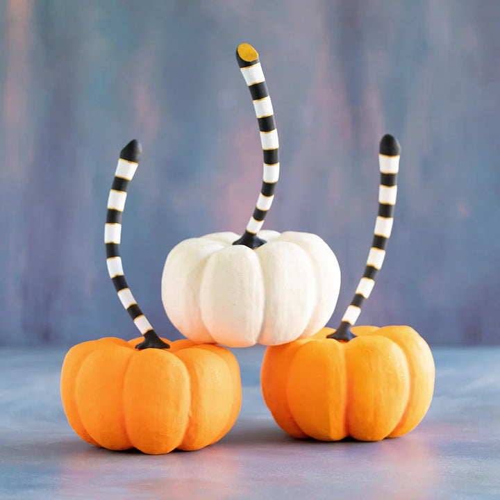 Glitterville large orange and cream pumpkin set featuring two orange pumpkins and one white pumpkin with playful black-and-white striped stems.