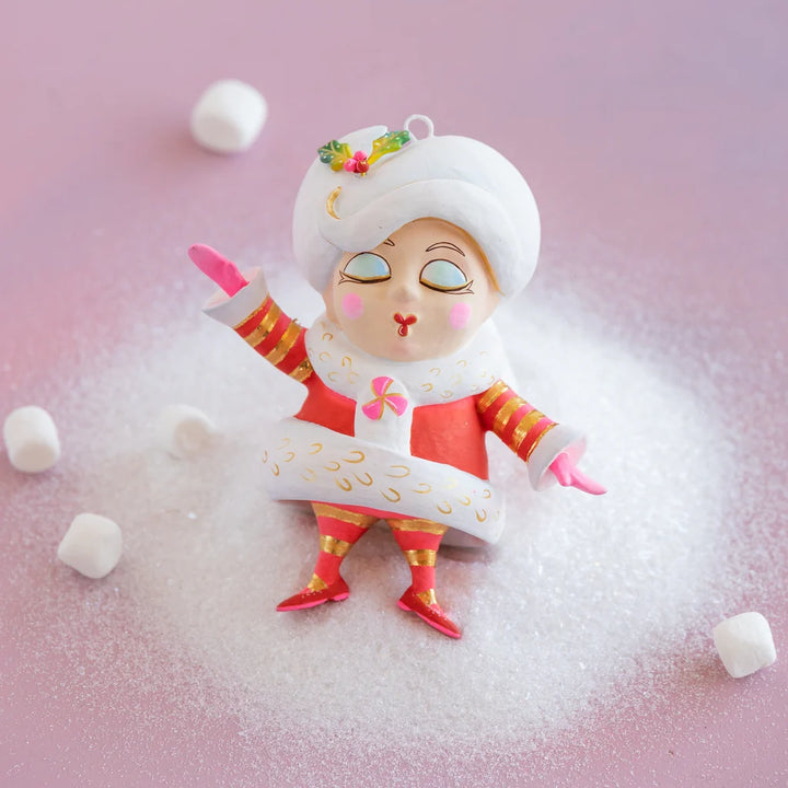 Glitterville Mini Madame Noel ornament featuring a cartoon-style Santa Mrs. Claus in a red suit with white and gold detailing, pink accents, gold-striped sleeves and stockings, and hand-painted facial details.