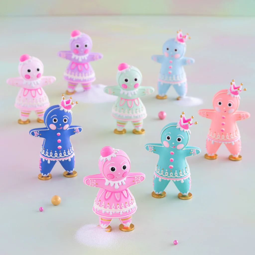 Glitterville multicolor Dippsy and Dough gingerbread figures displayed together in a whimsical pastel Christmas scene, featuring pink, blue, mint, lavender, and coral figures with detailed white and pink icing, colorful buttons, gold shoes, decorative hats and crowns, and intricate gingerbread-inspired designs. A playful collection of colorful holiday figures for Christmas decorating and seasonal displays.