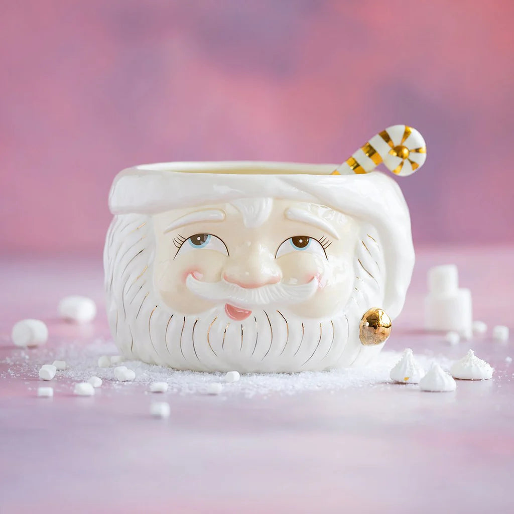 Glitterville Papa Noel ceramic Santa Claus punch bowl with a white Santa face, gold accents, and a matching gold and white striped ladle, styled with festive marshmallow details.