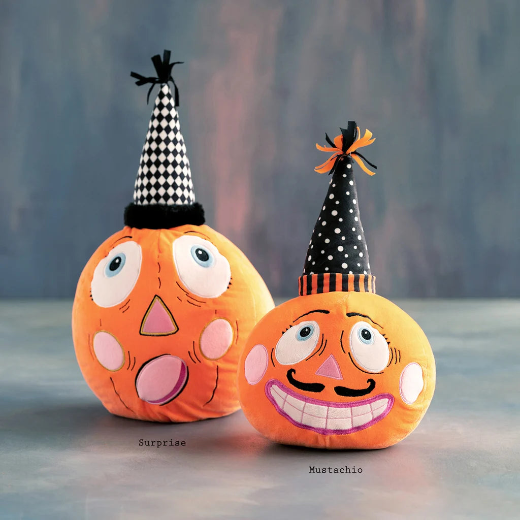 Glitterville Party Pumpkins featuring two whimsical orange pumpkin plushes, one with a mustache and both wearing black-and-white party hats. Names labeled under each plush for easy distinguishing. 