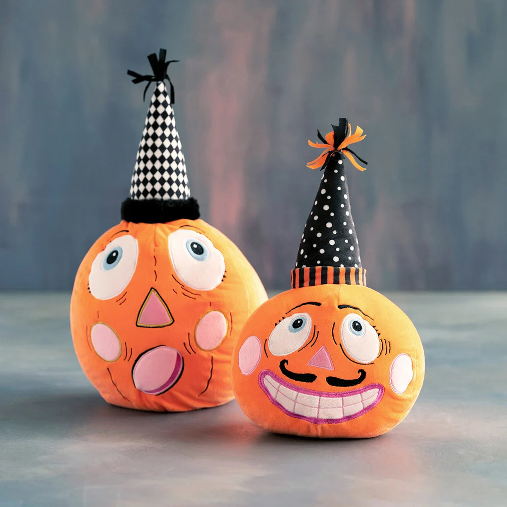 Glitterville Party Pumpkins featuring two whimsical orange pumpkin plushes, one with a mustache and both wearing black-and-white party hats. 