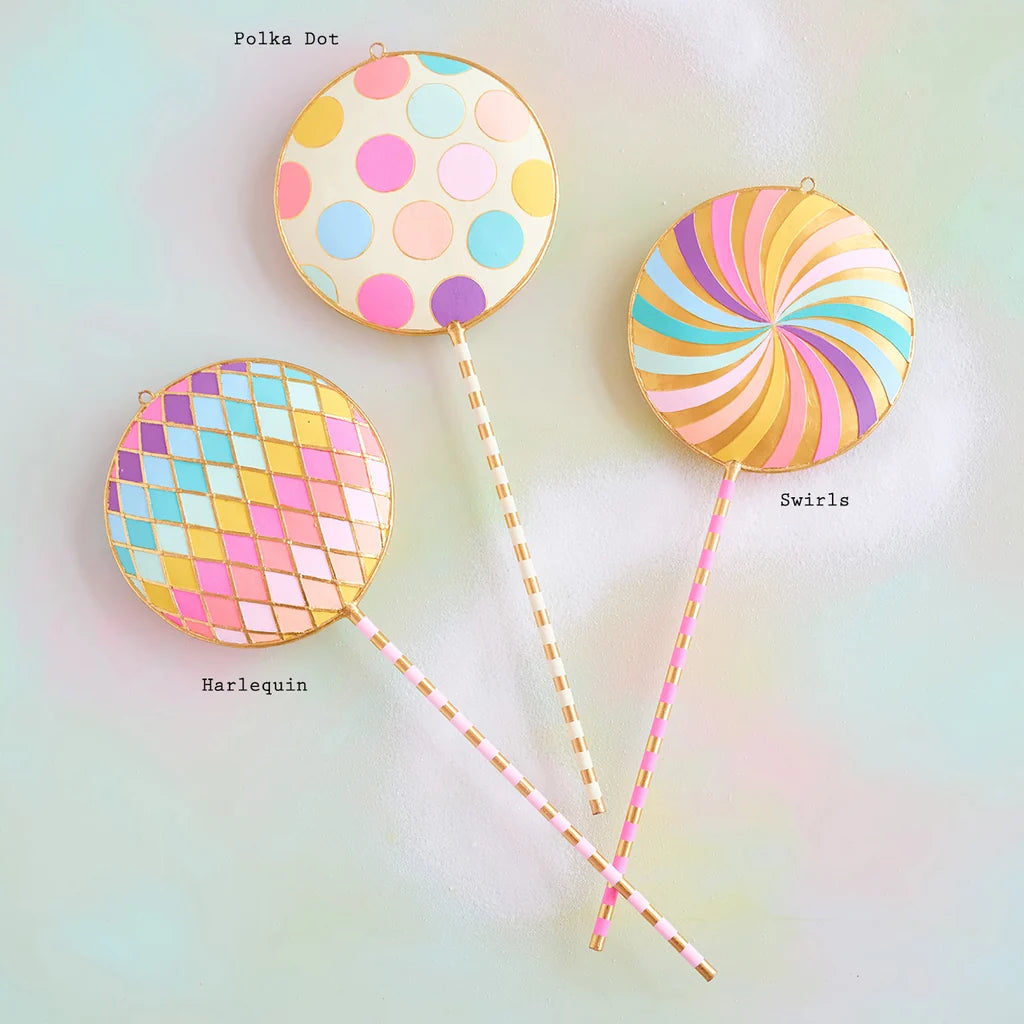 Glitterville pastel Licky Lollipop display set featuring three whimsical oversized lollipops with colorful polka dots, rainbow swirls, pastel pink, blue, yellow, and lavender patterns, and gold accents. Pattern labeled are displayed for easy distinguishing. 