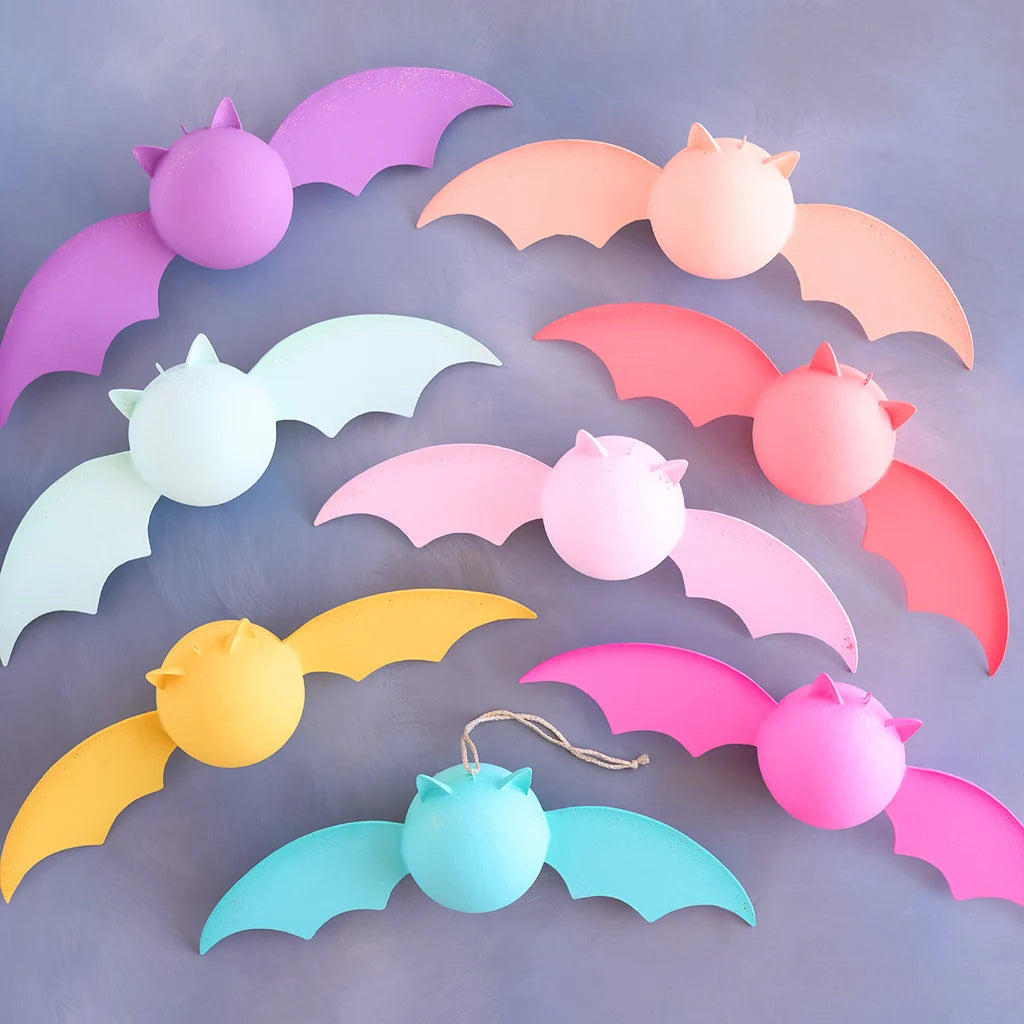 Glitterville pastel Rainbow Bat display set featuring whimsical bat decorations in pink, hot pink, yellow, peach, mint, blue, teal, and purple with coordinating round accents.