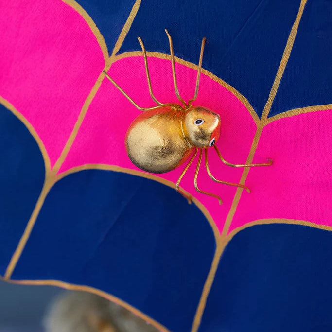Close-up detail of Glitterville Pinky Itchy Witchy showing the gold spider detail on her web design dress skirt. 