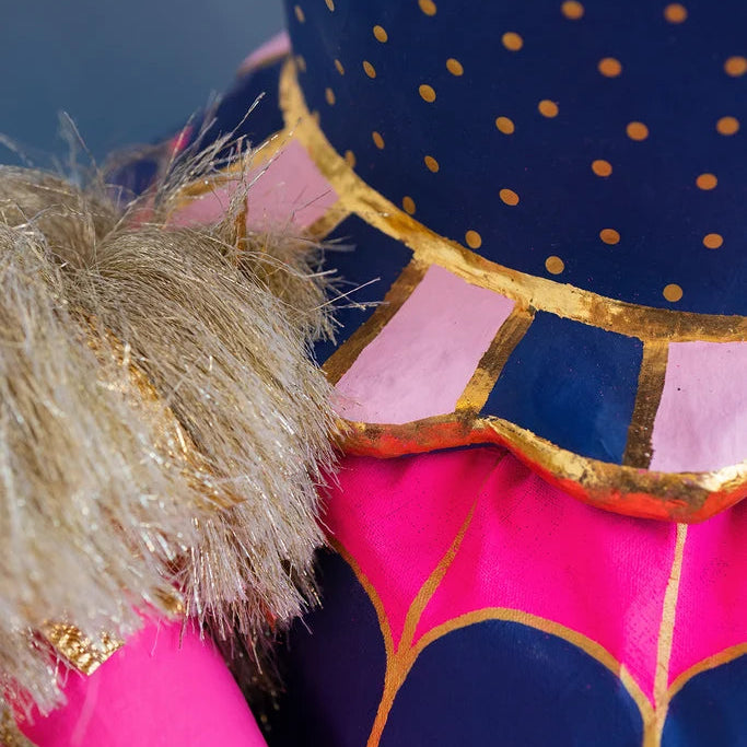 Close-up detail of Glitterville Pinky Itchy Witchy showing the scalloped edge of her top, and the beginning of her dress skirt. 