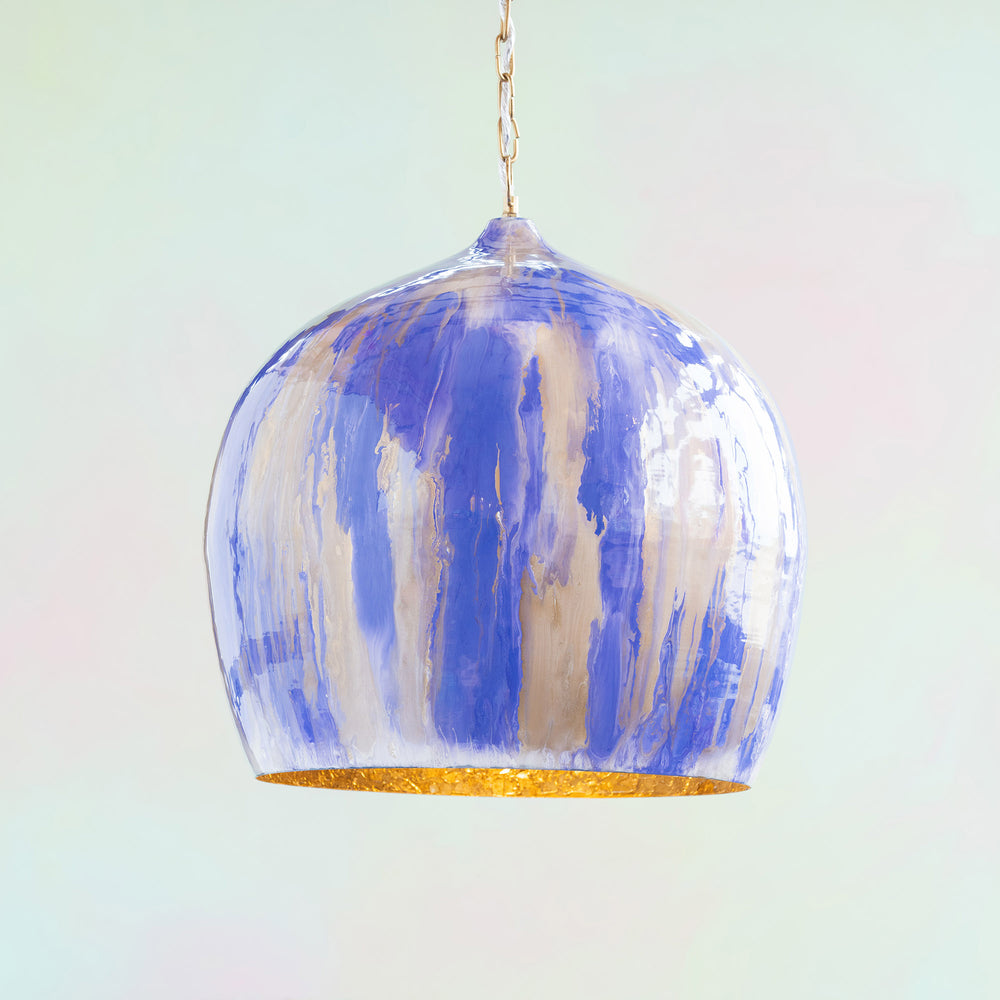 Image of Glitterville's Purple Colored Rainbow Bubble Pendant Light Hanging in front of a pastel tie-dye background. 