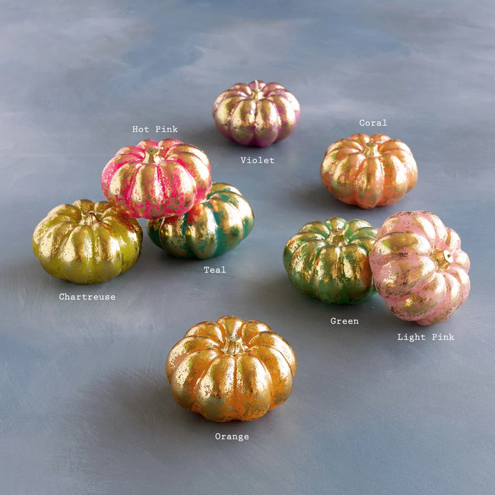 Glitterville Rainbow Pumpkin Candle Set featuring colorful pumpkin-shaped candles with shimmering gold accents in pink, green, yellow, orange, and purple. Color labels are displayed near each candle for easy distinguishing. 