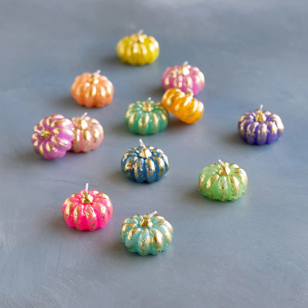 Glitterville Rainbow Pumpkin T-Light Candle Set featuring colorful mini pumpkin candles with shimmering gold accents in pink, orange, yellow, green, blue, and purple.