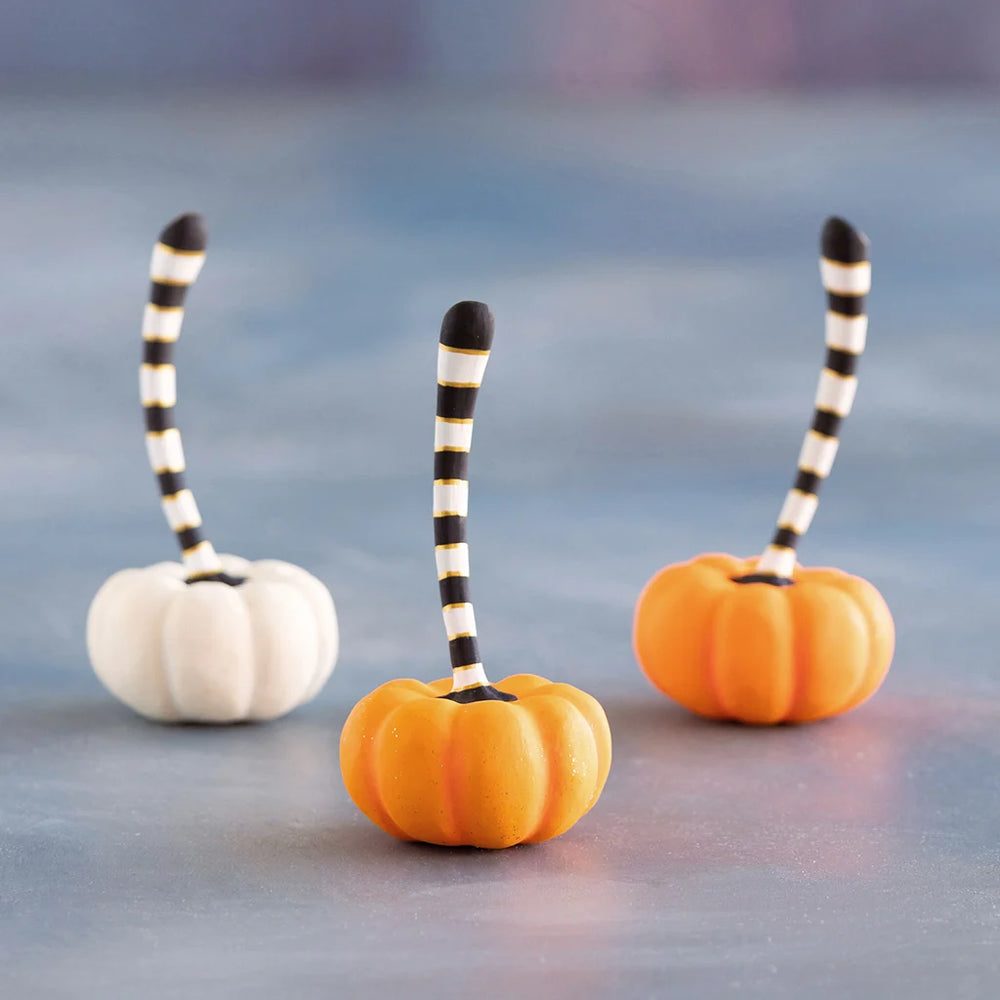 Glitterville small orange and cream pumpkin set featuring two orange pumpkins and one white pumpkin with playful black-and-white striped stems.