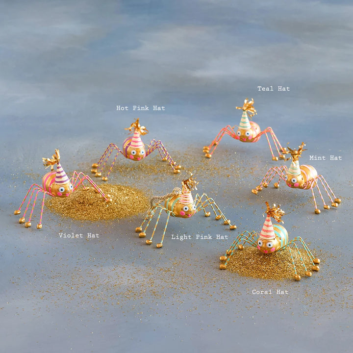 Glitterville Spectrum Spinderella spider ornament set featuring whimsical colorful Halloween spiders with striped party hats, playful details, gold accents, and glittering legs, perfect for festive Halloween tree decorating and spooky-season displays. Hat colors are labeled near each ornament for easy distinguishing. 