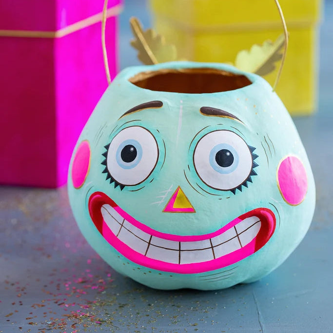 Glitterville Squashy Pumpkin Pixie Bucket in pale mint blue with large expressive eyes, pink cheeks, gold accents, and a wide toothy smile.