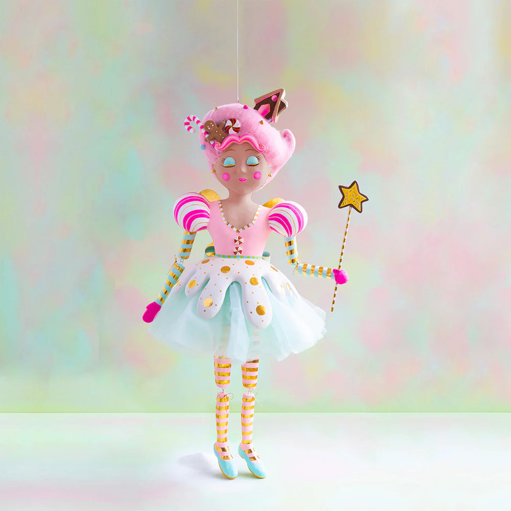 Large Glitterville Sugar Plum Fairy display figure with warm brown skin, pink candy-inspired hair decorated with gingerbread and peppermint accents, a pastel pink and white dress with gold details, striped sleeves and legs, mint shoes, and a star-tipped wand.