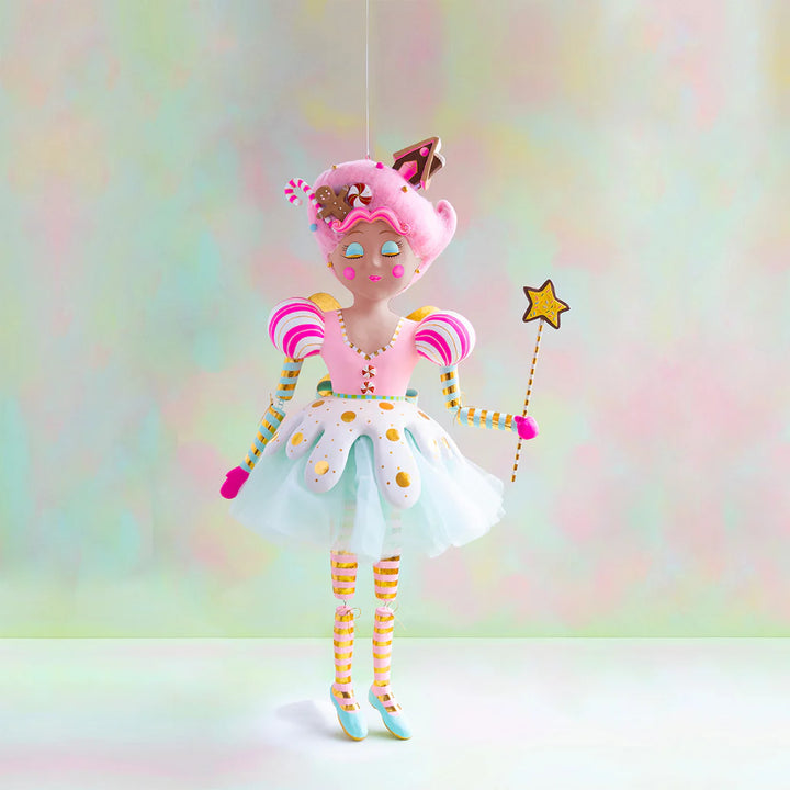 Large Glitterville Sugar Plum Fairy display figure with warm brown skin, pink candy-inspired hair decorated with gingerbread and peppermint accents, a pastel pink and white dress with gold details, striped sleeves and legs, mint shoes, and a star-tipped wand.